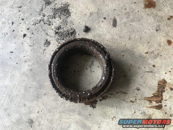 Worn, greasy bearing on concrete floor