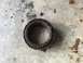 1989 Ford Bronco - A heavily used bearing sits on a concrete surface, showing signs of significant wear and tear.