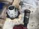 1989 Ford Bronco - Disassembled vehicle axle and hub assembly components are laid out on a wooden surface.
