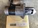 1993 Mazda MX-3 - Starter motor weighs 26.10 on an electronic scale, likely for a vehicle engine and transaxle change.