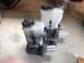 1993 Mazda MX-3 - A pair of brake master cylinder assemblies with plastic reservoirs and metal pistons are shown.