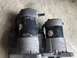 1993 Mazda MX-3 - Two starter motors, likely for a vehicle, are shown side-by-side on a concrete surface.