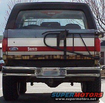 Rear of a gray, red, and white Ford Bronco with a spare tire carrier and a trailer hitch