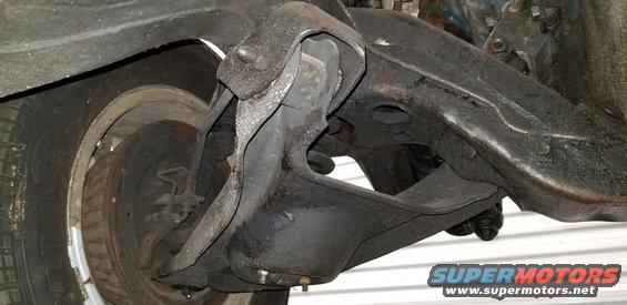 Underside of vintage car front suspension with tire and wheel