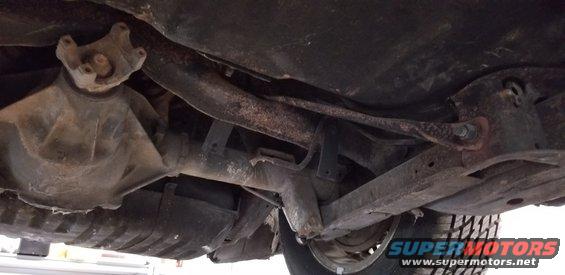 Underside of a vehicle showing rear differential, driveshaft, and suspension.