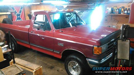 Red 1991 Ford F-150 pickup truck parked indoors