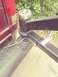 1996 Ford Bronco - Close-up of a trailer hitch assembly connected to the rear of a red SUV.