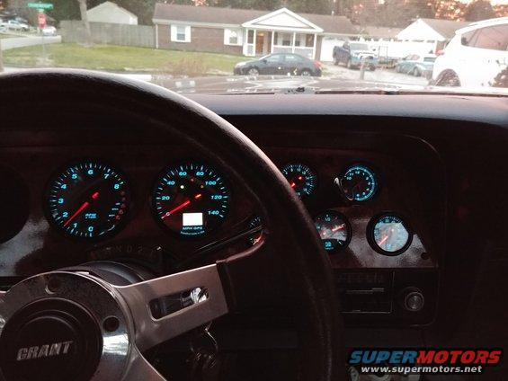 1977 Ford Ranchero interior showing Grant steering wheel and aftermarket gauges with blue illumination