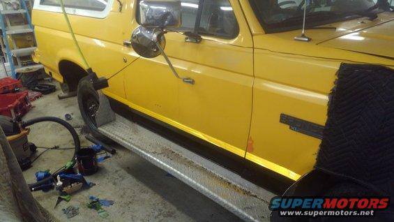 Yellow 1996 Ford Bronco side view with running boards