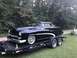 1951 Mercury Sedan - A classic black 1951 Mercury Sedan is loaded onto a trailer, ready for transport.