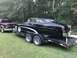 1951 Mercury Sedan - A black 1951 Mercury Sedan is being transported on a trailer, with a pickup truck visible in the background.