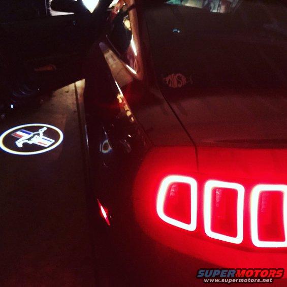 2014 Ford Mustang rear with illuminated pony logo on the ground