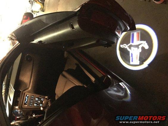 Car interior with a projected Mustang logo on the ground