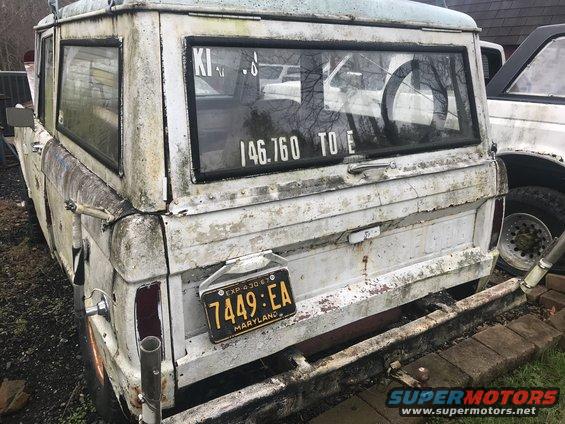 Rear view of a weathered 1967 Ford Bronco with Maryland plates. Another vehicle is partially visible to the right