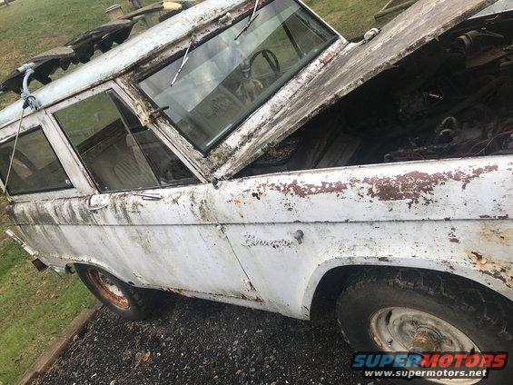 White 1967 Ford Bronco with hood open, showing rust and wear