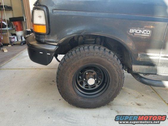 Dark gray 1993 Ford Bronco front fender and wheel, with 'BRONCO' badge visible