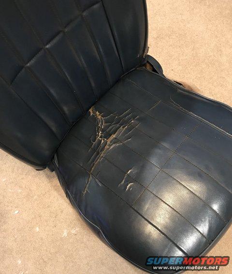 Blue vinyl car seat with ripped driver's side cushion