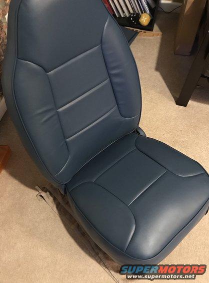 Blue vinyl car seat with horizontal stitching on the backrest and seat cushion
