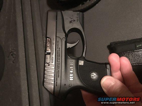Ruger pistol held in hand, showing "RUGER" and ".380 AUTO" markings