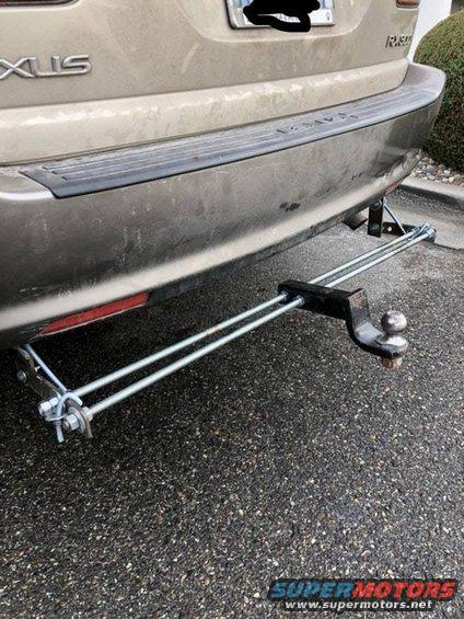 Tan SUV rear bumper with a trailer hitch attached