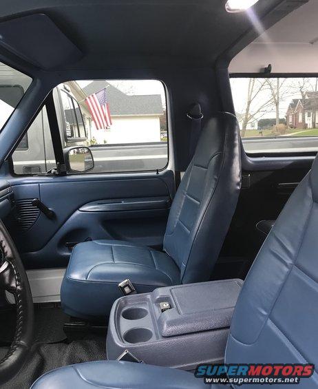 Blue leather seats and dashboard of a 1995 Ford Bronco, viewed from the passenger side