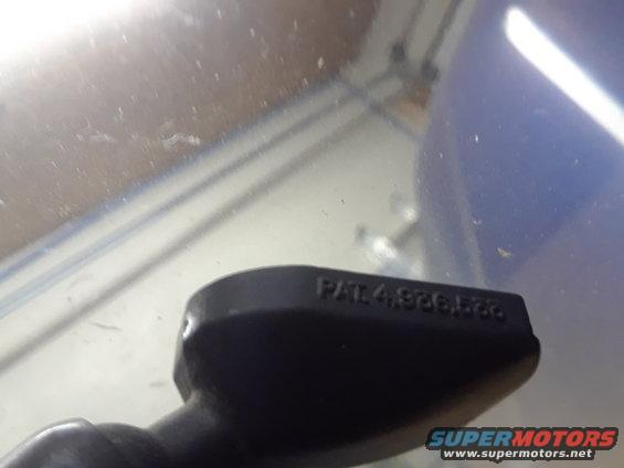 Black plastic part with raised text "PAT. 4,926,566"