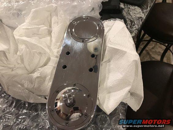 Chrome plated automotive part with circular covers and screw heads
