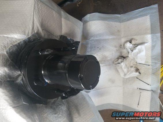 black painted vehicle hub assembly covered in paper towels