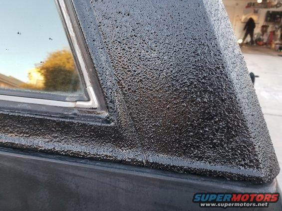 Black textured roofline and window trim on a vehicle