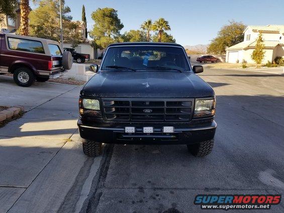 Black 1993 Ford Bronco front view with aftermarket lights