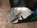 1970 Volkswagen Beetle - A detached engine oil cooler assembly, a finned radiator and copper tubing, lies on a tiled floor.