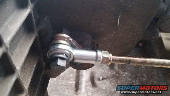 Close-up of a rod end connected to a threaded rod, likely part of a transmission linkage