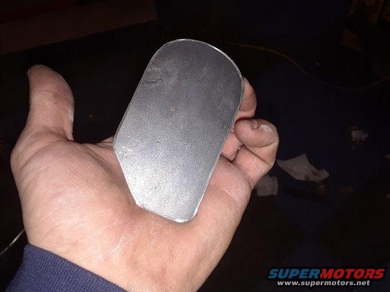 Hand holding a curved metal piece