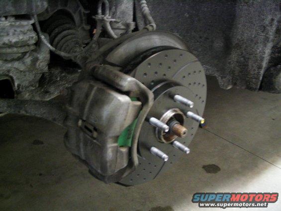 Brake caliper and drilled rotor assembly