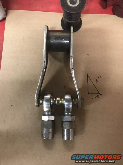 Metal suspension linkage with two rod ends and a bushing, next to a hand-drawn triangle with dimensions 3" and .75"