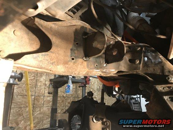 Close-up of rusty frame and suspension parts with welds