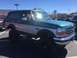 1979 Ford Bronco - This two-tone SUV, likely a 1992 model, is equipped with large off-road tires and fender flares.