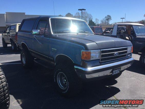 Blue Ford Bronco, 3/4 front view. License plate reads 20210