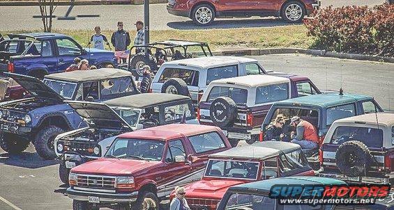 Several Ford Bronco SUVs parked together, some with hoods open