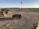 1992 Jeep Wrangler - Child driving a toy Jeep Wrangler in a desert setting with camping gear visible.