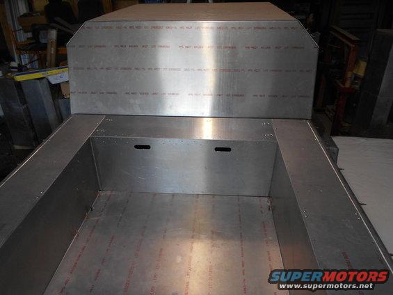 Aluminum truck bed interior with visible text on side panels
