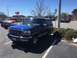 1979 Ford Bronco - This blue Ford Bronco is parked in a lot with other vehicles visible.