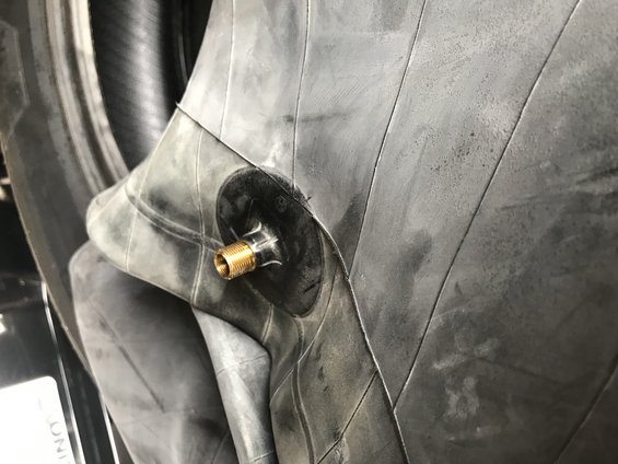 Inner tube with brass valve stem, close-up view