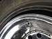 1970 Volkswagen Beetle - A close-up view shows a damaged tire bead and a chrome rim with a visible valve stem hole.