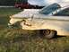 1960 Ford Starliner - This heavily damaged white car, likely a 1959 model, shows significant rear quarter panel damage and a chrome bumper.