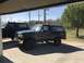 2008 Ford Focus - Two Ford Broncos are visible, one dark gray and one black, parked outdoors under a covered area.