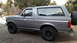 1995 Ford Bronco - This gray Ford Bronco is shown from the side, aftermarket wheels and a spare tire mounted on the rear.