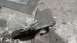 1984 Ford Bronco - A metal bracket with a bolt is shown on a workbench, possibly a custom part.