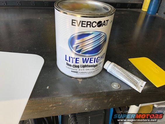 Can of Evercoat Lite Weight filler with a squeegee and tube of hardener