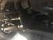 1984 Ford Bronco - Close-up of the steering and suspension system, showing various metal rods and bolts.